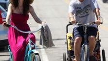 Just like us(ish): Adam Sandler tows kidlets in bike trailer