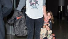 Milla Jovovich lets her daughter ride the luggage
