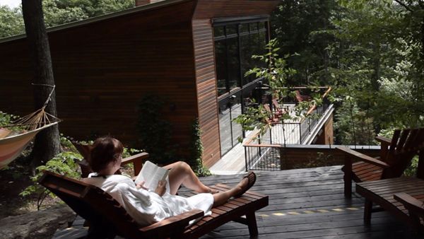Photo of a woman lounging outdoors at La Source Bains Nordiques