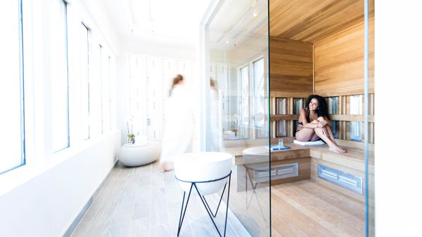 Woman sits in a room at Spa Eastman