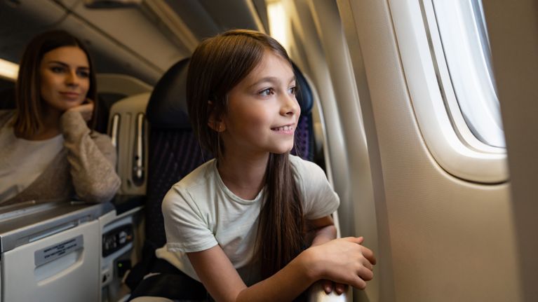 Happy girl traveling by plane