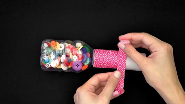 wrapping washi tape around a toilet paper roll