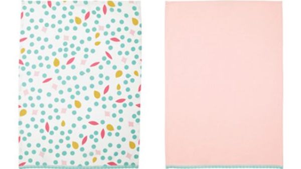 Tea towel with pink on one side and a green dot pattern on the other
