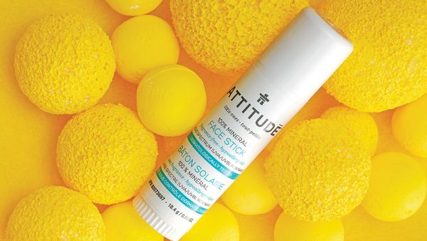 Sunscreen face stick sitting on yellow orbs