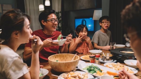 family and cousins having reunion dinner at home