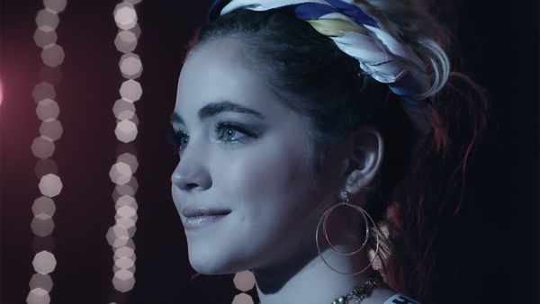 Promo image for GO! Live Your Way showing a girl on a stage looking into the spotlight