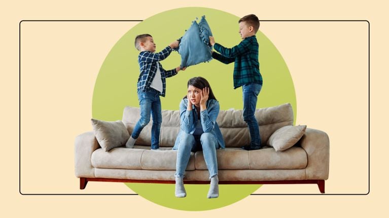 Mom meditates while kids jump and play around her