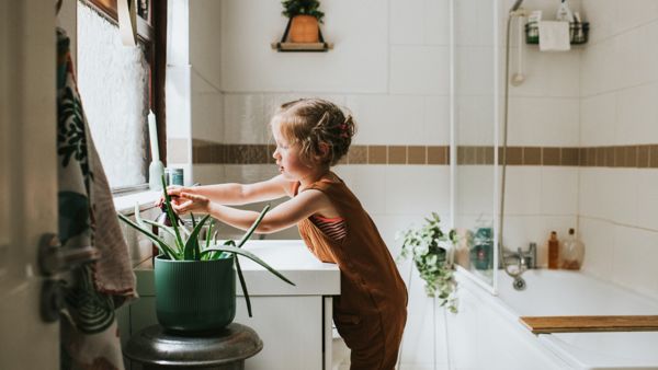 Little Girl Washing her Hands at a Bathroom Sink