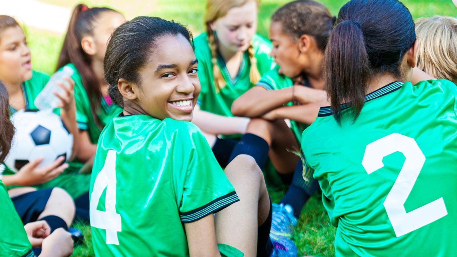 A budding girl stretches boldly in a sports uniform her budding form subtly hinted at