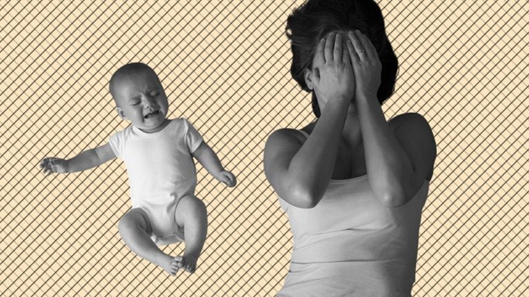 Mother and crying baby on a carpet while mother covers her face