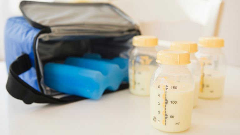 Breast milk in bottles next to ice cooler