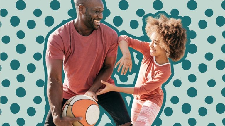 A dad and daughter play basketball