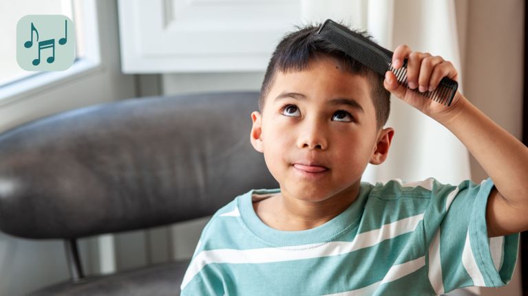 A child combs his hair.