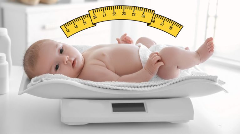 A baby lies on a digital infant scale wearing only a diaper, with a yellow measurement arc added above to represent length tracking.