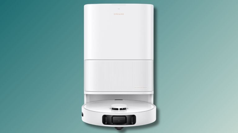 Front view of the Dreame L40s Ultra CE robot vacuum docked inside its sleek white auto-empty and mop-cleaning base station, set against a teal gradient background.