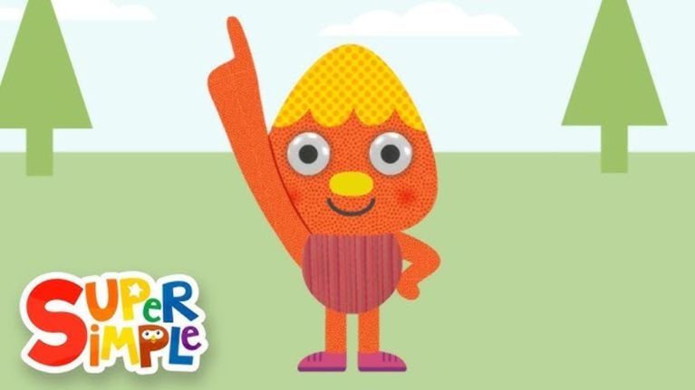 An orange, textured cartoon character with a round head and googly eyes raises one hand in the air while standing on grass. Trees and clouds appear in the background with the “Super Simple” logo nearby.