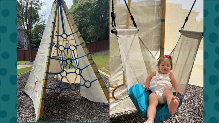 Bijou Build Playground in backyard and toddler in hanging swing