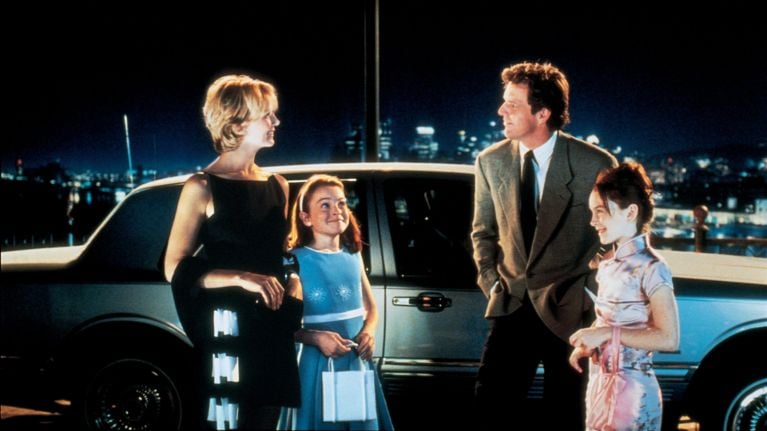 The four main characters in 1998's The Parent Trap, standing by a car in a nighttime scene