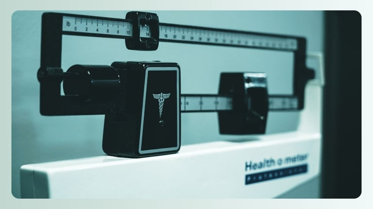 A close-up of a medical scale with a teal overlay.