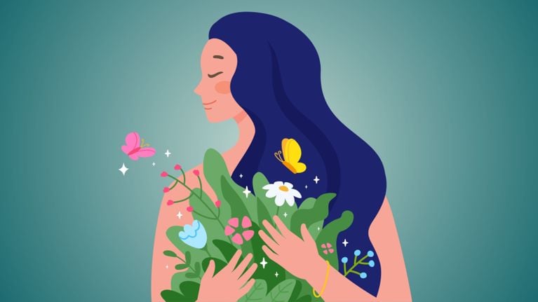 A mom clutches her head while sitting in front of a laptop.