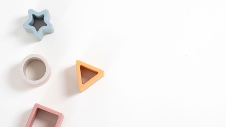 Wooden blocks in varying shapes against a plain background.