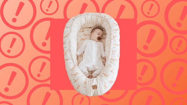 Baby sleeping in a soft, oval-shaped Housbay baby nest with a fox pattern, set against a red-orange background with warning icons. This product has been recalled in Canada due to strangulation, entrapment, choking, and fall hazards.