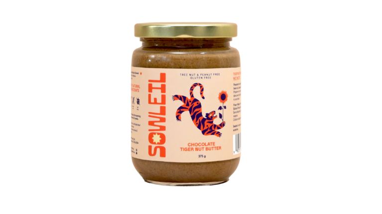 A glass jar with a gold lid, featuring an illustrated tiger and sunflower on the label.
