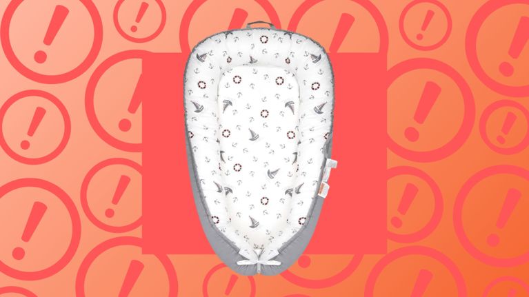 A recalled FFQRLP Brand Baby Lounger with nautical-themed fabric and grey sides is displayed against a red-orange warning background with exclamation marks, highlighting safety concerns including strangulation, entrapment, and fall risks.