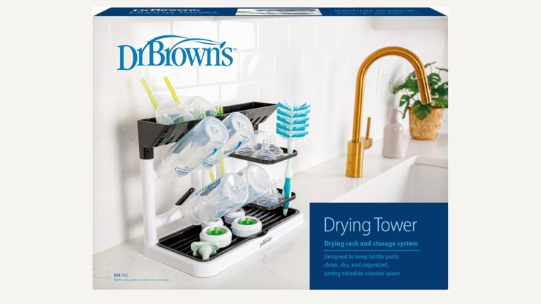 A two-tier drying rack for baby bottles and accessories, placed on a white kitchen counter.