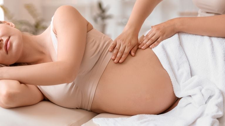 A pregnant woman receiving a massage