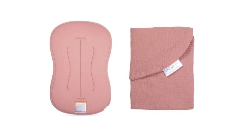 A blush pink baby lounger and matching muslin cover from Snuggle Me are displayed side by side on a white background.