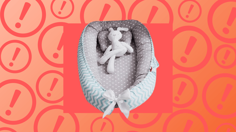 A baby nest with a bunny toy on it, shown against an organge background covered in exclamation mark symbols, indicating an alert or warning.