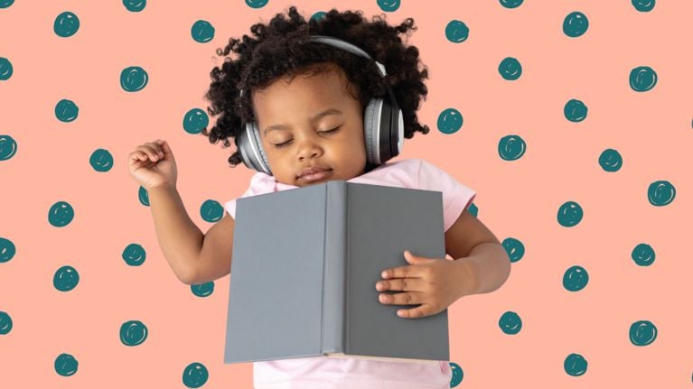 A young child wearing headphones sleeps with a book resting on their chest against a peach background with teal polka dots.