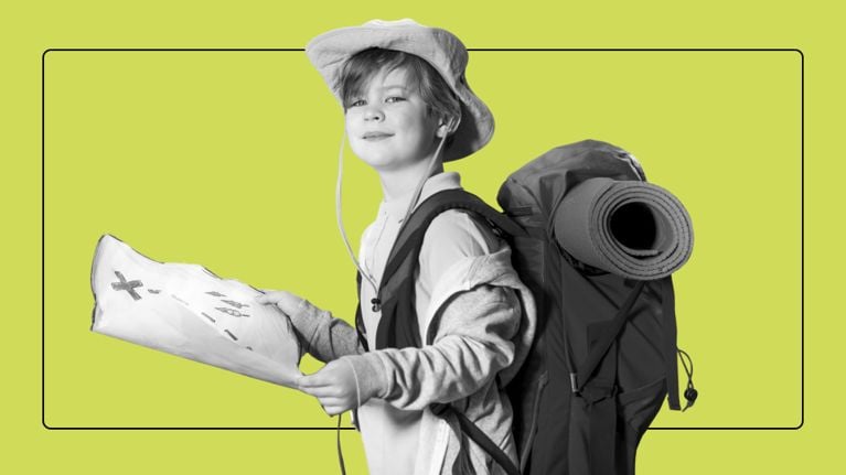 Young boy in a sun hat and large hiking backpack holding a hand-drawn treasure map for a scavenger hunt.