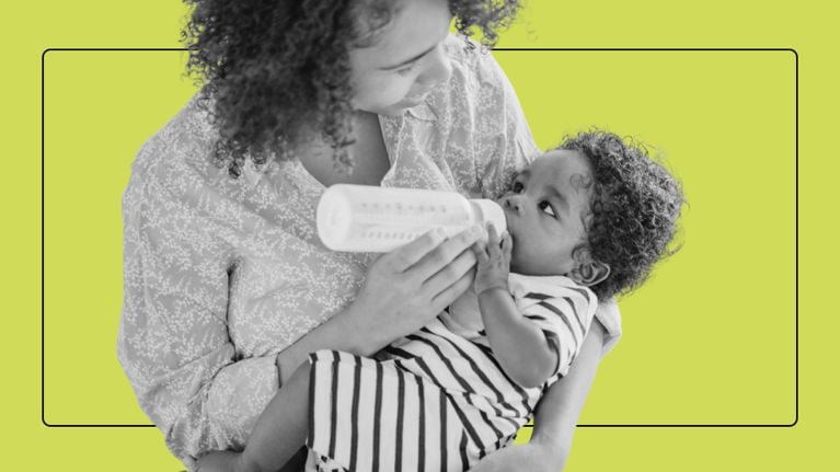 A mother cradles and bottle-feeds her infant against a bright green background.