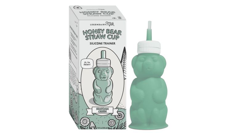 A silicone trainer cup shaped like a bear with a built-in straw, designed to help babies transition to straw drinking. The seafoam green cup sits beside a white box featuring a "Beary" mascot and floral line art.