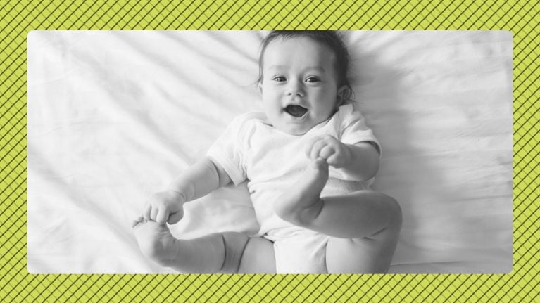 A baby of roughly four months of age with a knit headband and striped top, displayed in black and white in front of a beige graphic