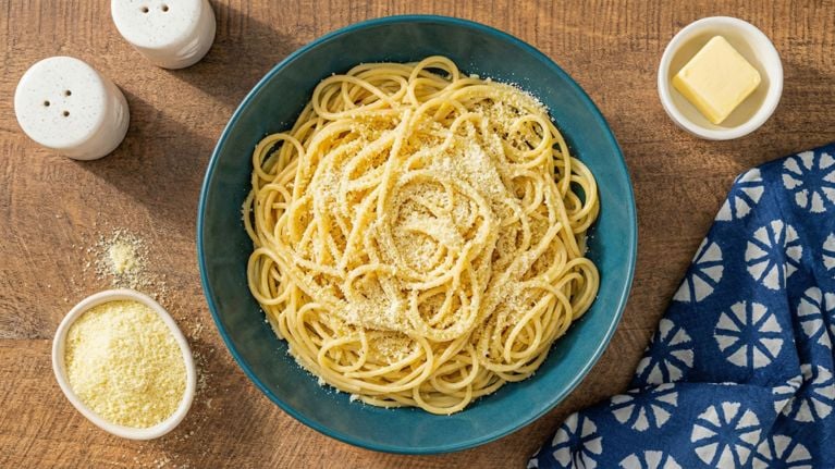 An overhead shot of a bowl of butter and cheese pasta.