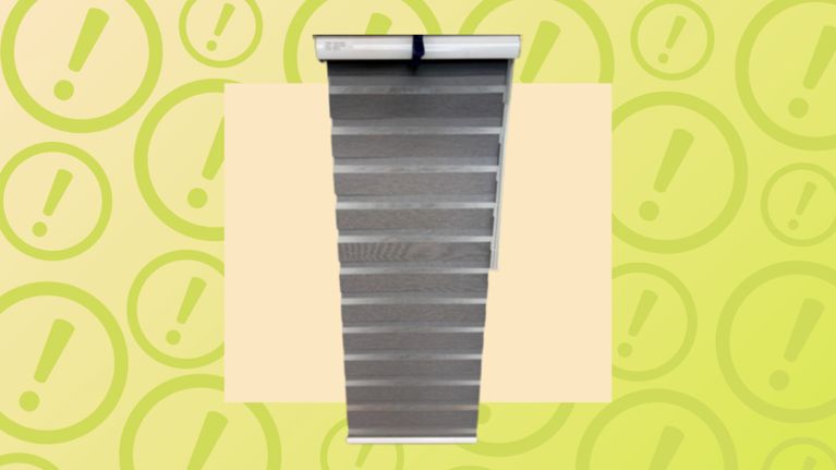 Grey zebra roller blinds with alternating sheer and solid fabric slats for adjustable light control.