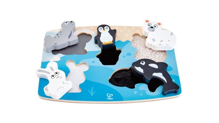Hape wooden arctic animal chunky puzzle with a seal, penguin, polar bear, orca, and hare on a blue sea base.