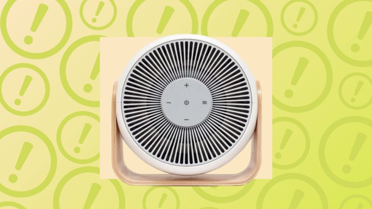 A white Breez baby fan on a light wood stand, centered over a background of yellow warning exclamation icons.