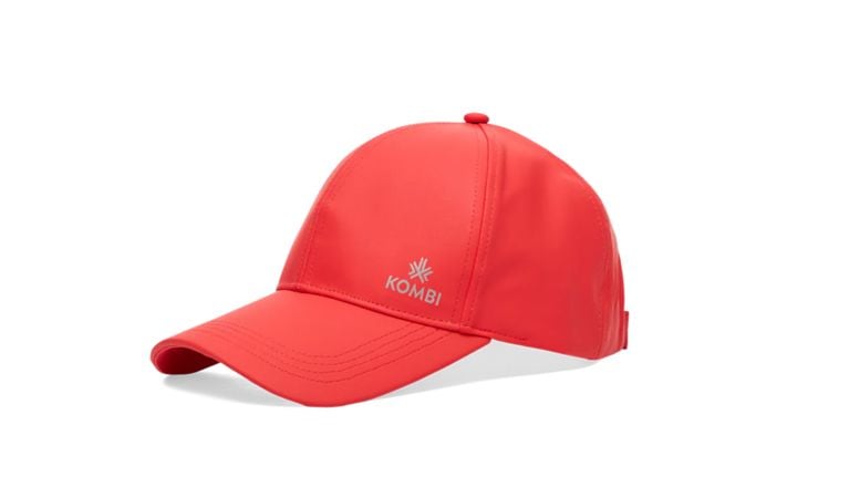 Vibrant red Kombi brand baseball cap with a moisture-wicking finish and a reflective silver logo on the front.