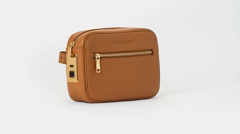 Tan pebbled leather Rachel Bloom crossbody camera bag with gold hardware and a front zippered pocket.