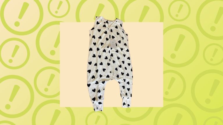 A white Bambi & Birdie romper with black hearts on a yellow warning background, indicating a product recall.