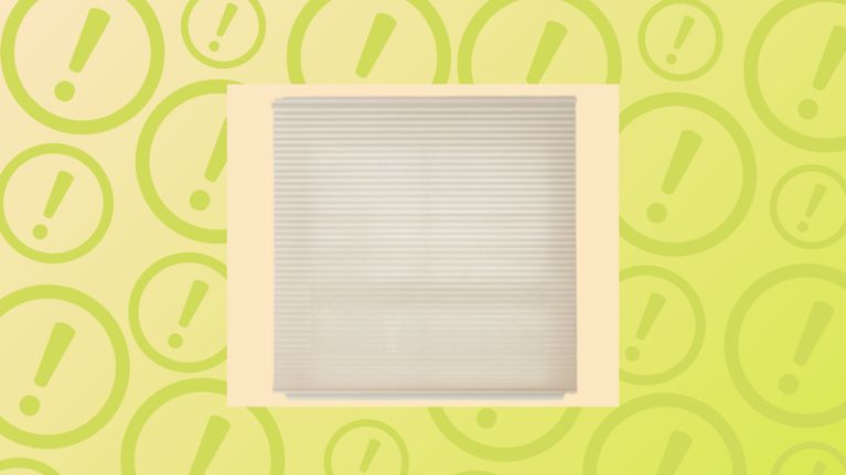 Cream-colored pleated horizontal window blinds shown against a background covered in yellow exclamation warning icons.