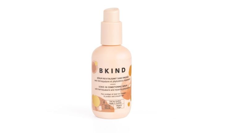 Bkind leave-in conditioning serum bottle with a pale peach label and bottle, photographed on a white background.