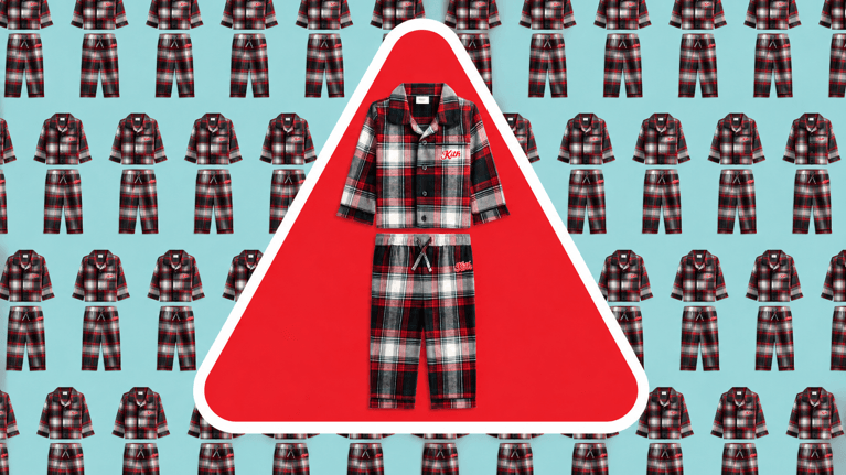 Children’s red, black and white plaid pajama set shown inside a red warning triangle with a thick white border, over a repeating pajama pattern on a Cornflower Puff blue background.
