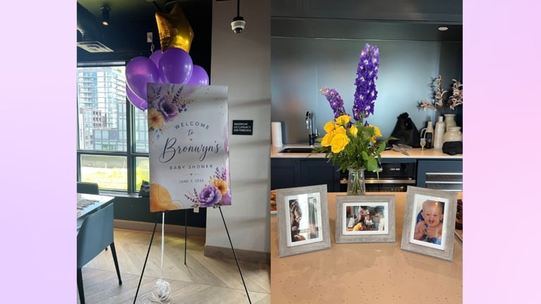 Baby shower welcome sign, flowers, and picture frames on a party room island