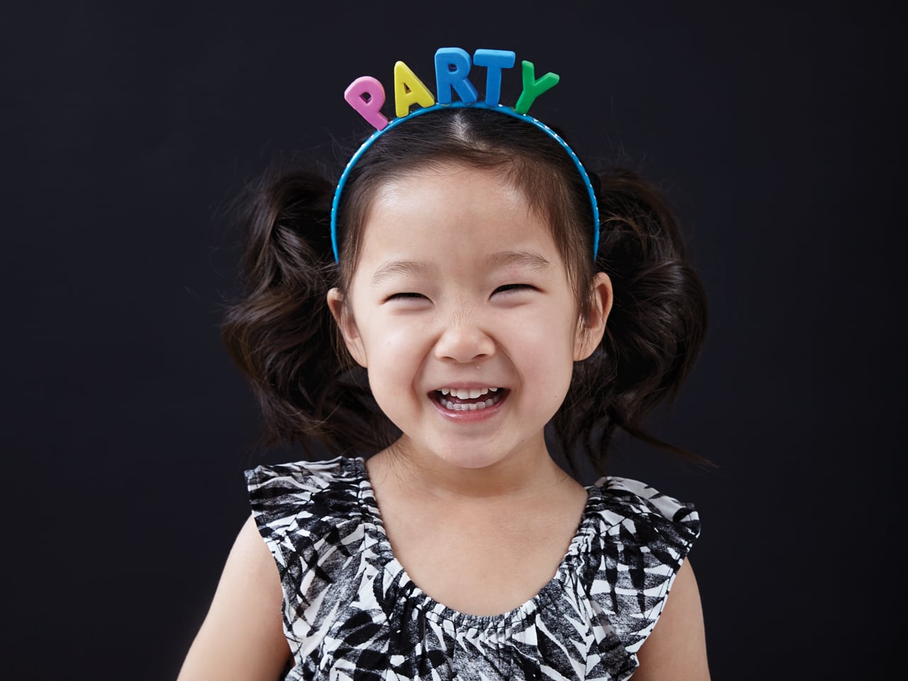 little girl wearing party headband