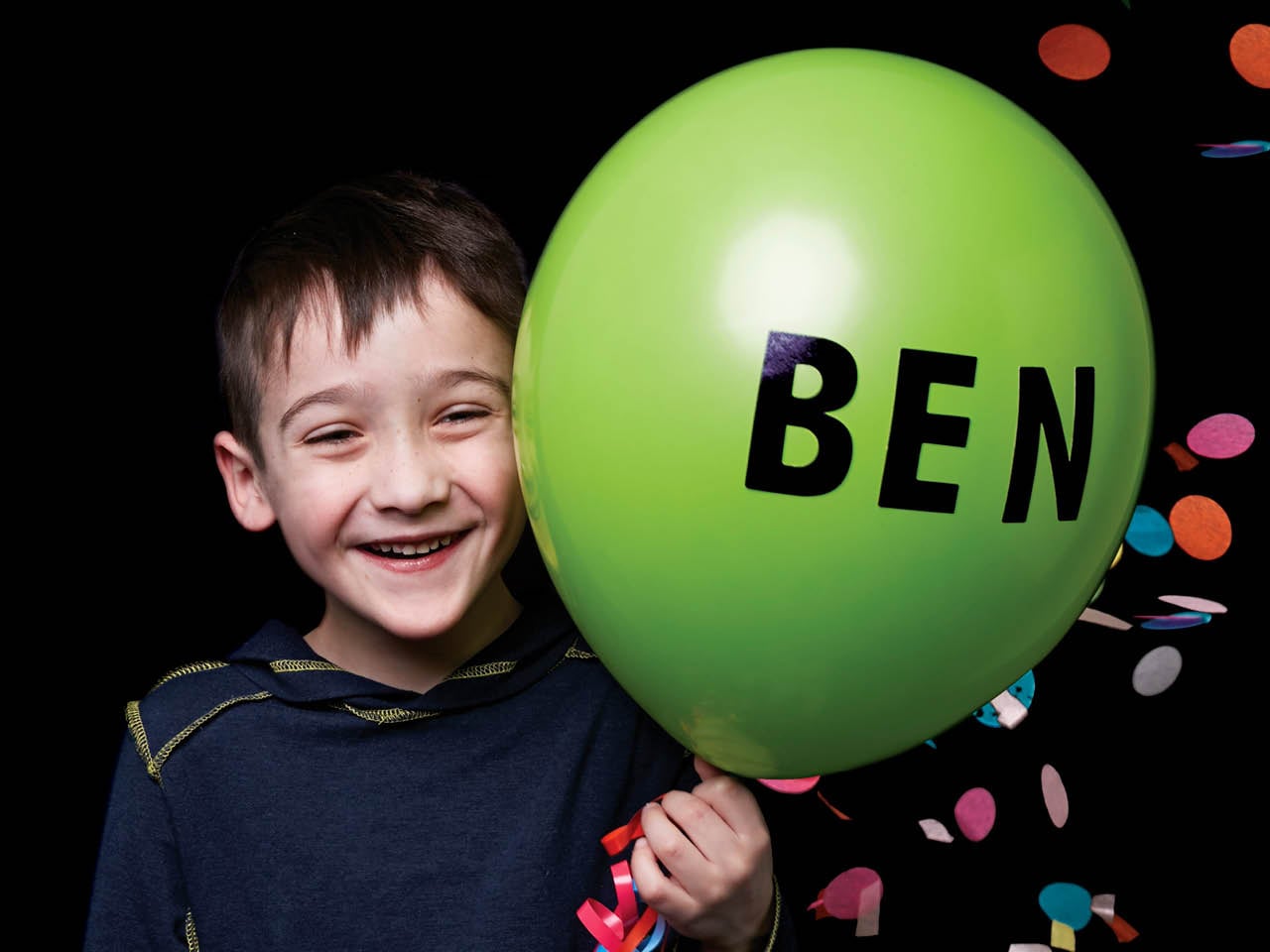 little boy holding a balloon